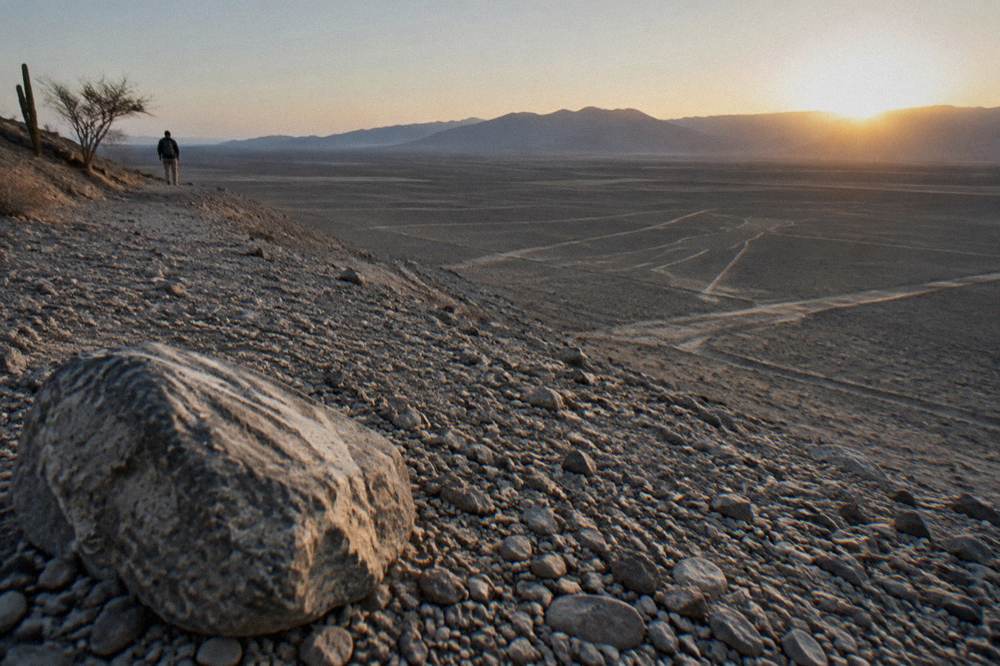 Vast flat desert plains with faint geometric lines etched across the surface