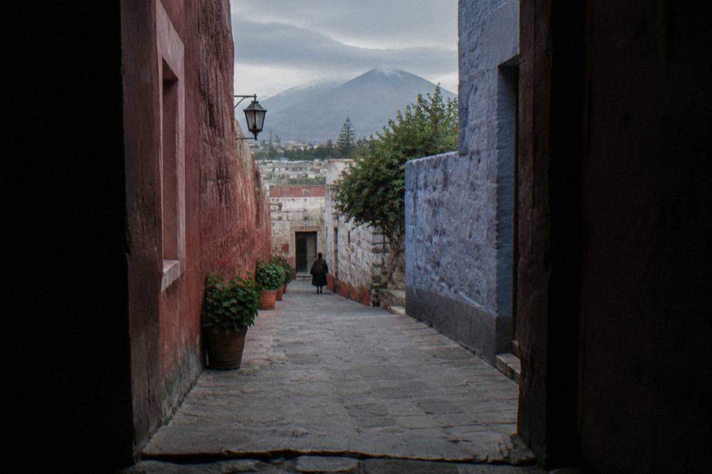 Cloistered orange walkways of a colonial monastery in Arequipa under a bright sky