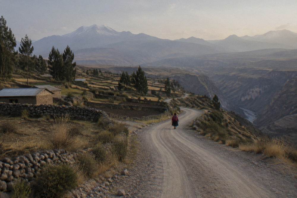 Small village with stone buildings and terraced fields on the canyon slopes