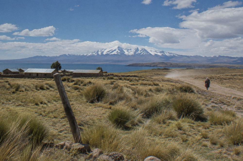 Open high plains with a snow-capped mountain range on the horizon under a wide sky
