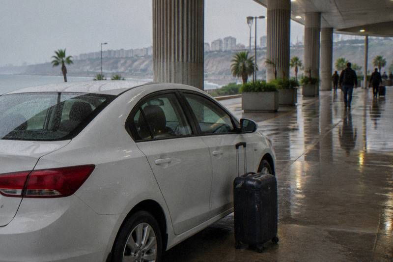 A private car waiting to meet arriving passengers at Cusco's airport terminal for a hotel transfer