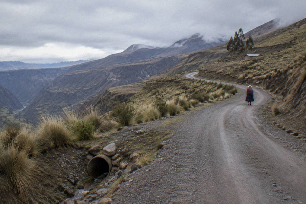 Winding mountain road climbing through high Andean puna toward Colca Canyon