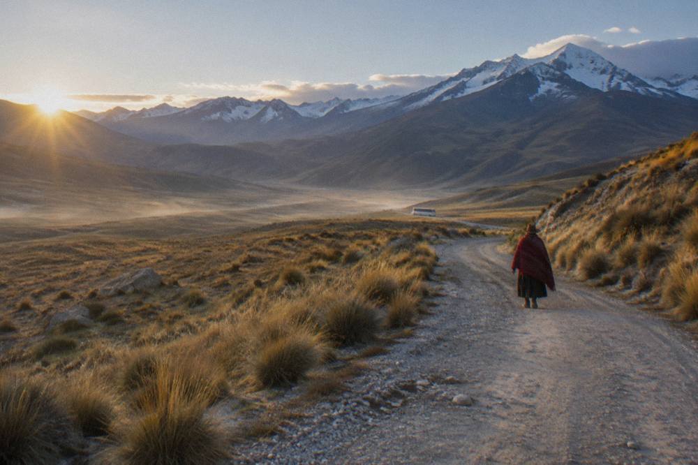 Highland road with open plains and distant mountains along the altiplano bus route