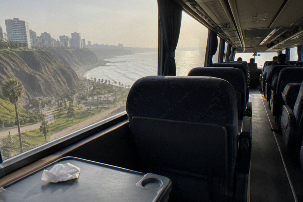 Interior of a long-distance tourist bus with reclining seats and wide windows