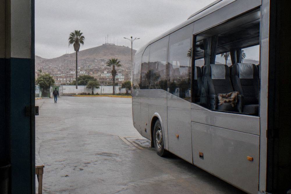 An empty long-distance bus with wide reclining seats and clean windows