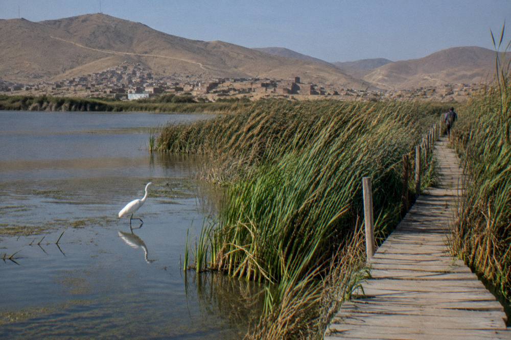 A high plateau lake ringed by dry hills under a wide open sky