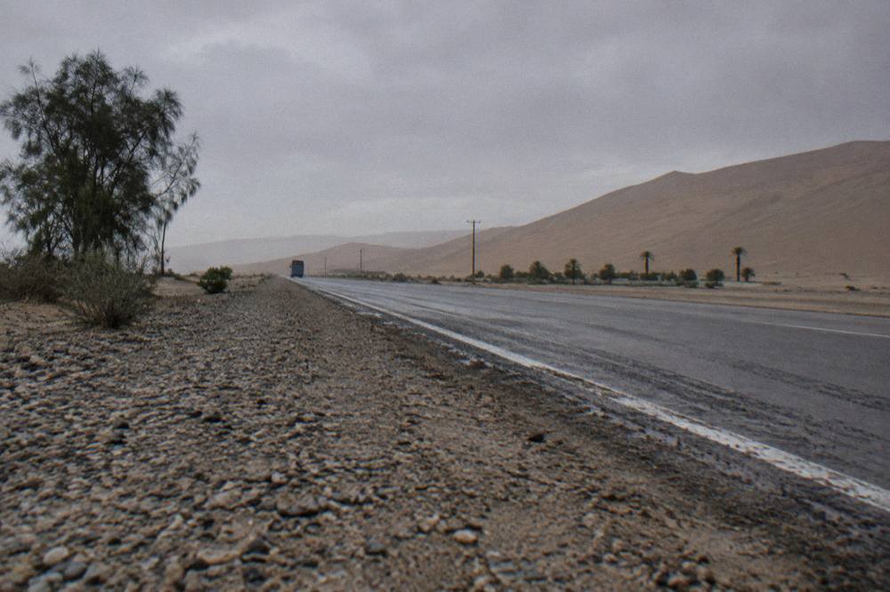 Open desert highway south of Lima with sand dunes rising near the road