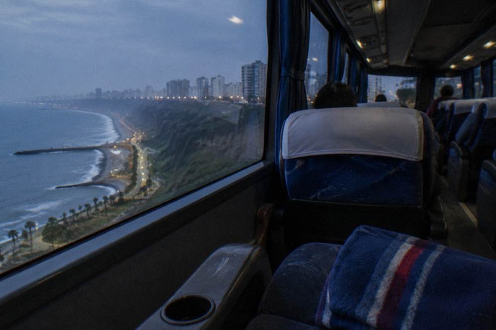 Reclining bus seats with blankets in a long-distance coach cabin