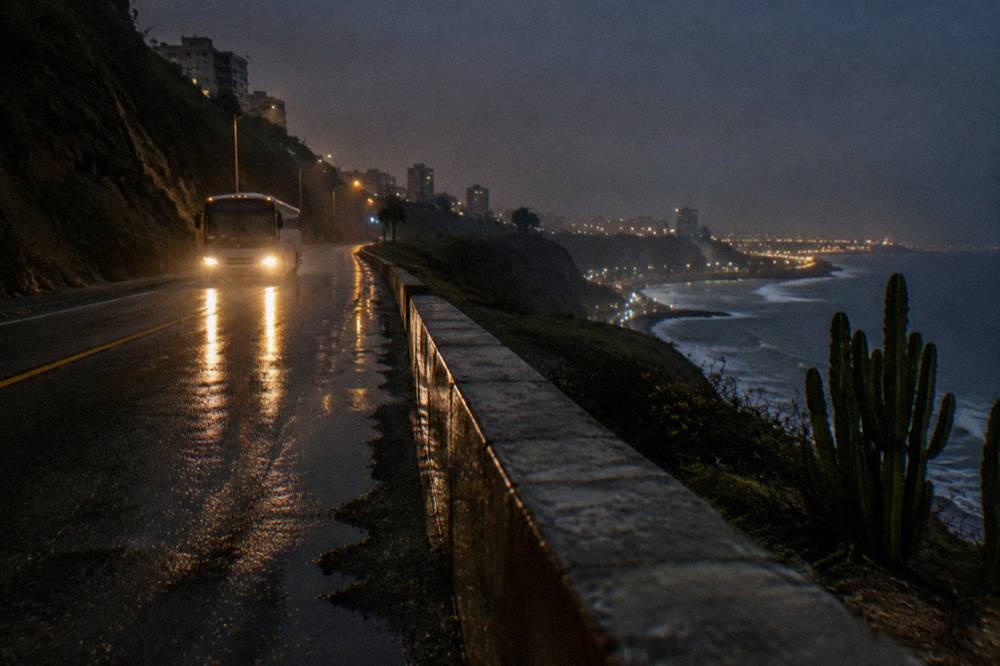 A night highway scene with a tour bus headlights on a mountain road above dark valleys