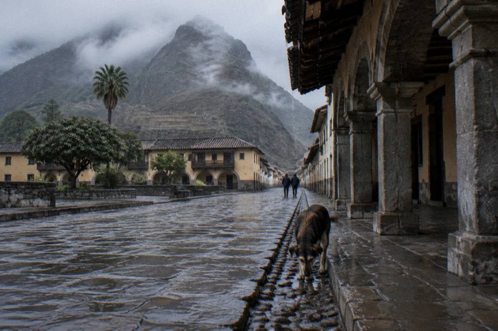 A colonial plaza in Cusco in early morning light with stone arcades and empty streets