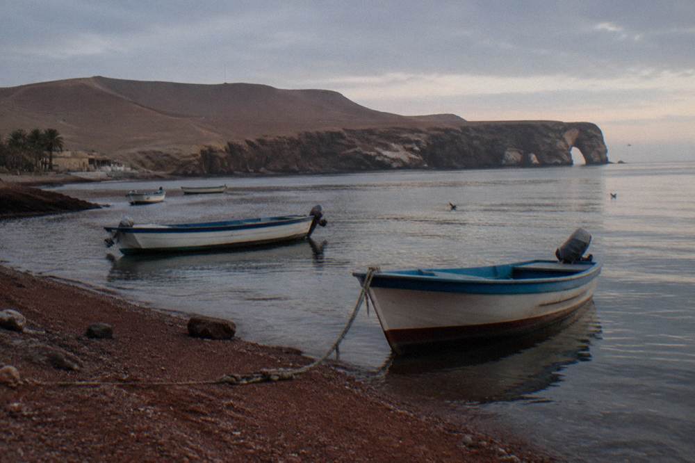 Small boats moored at a calm bay in early morning light