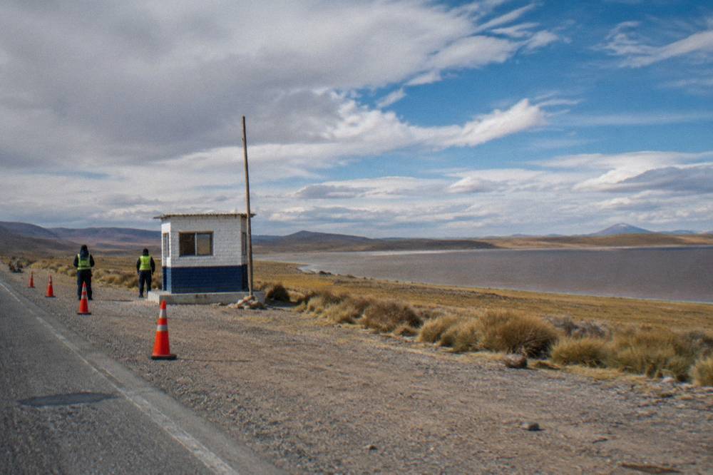A police checkpoint beside a highway in the Peruvian altiplano under a wide sky