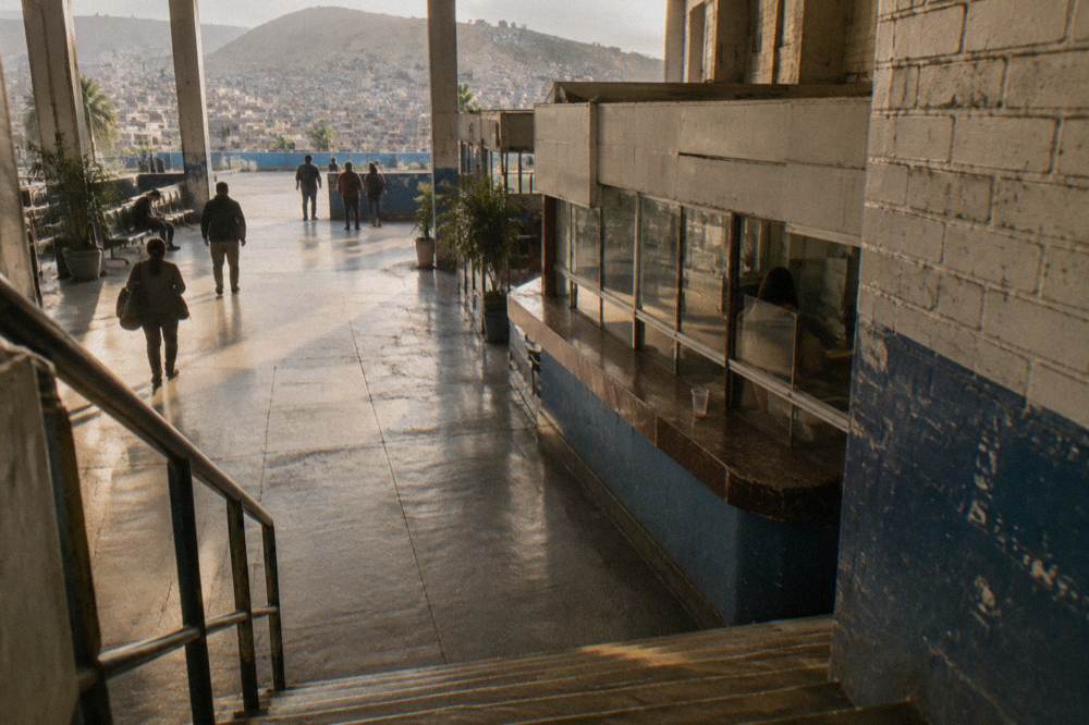 A ticket counter at a Peruvian bus terminal with departure boards above the windows